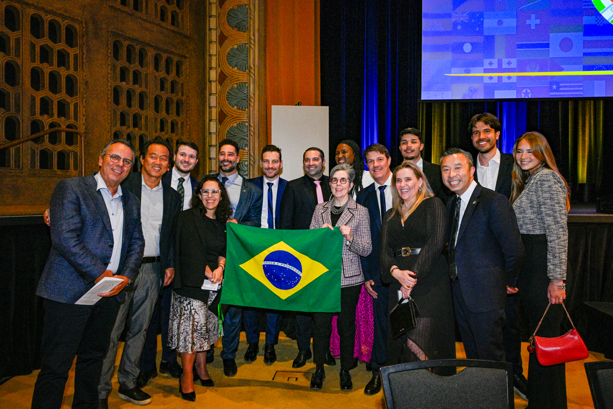 Guests at the 2026 Celebrate Trade gala holding the flag of Brazil